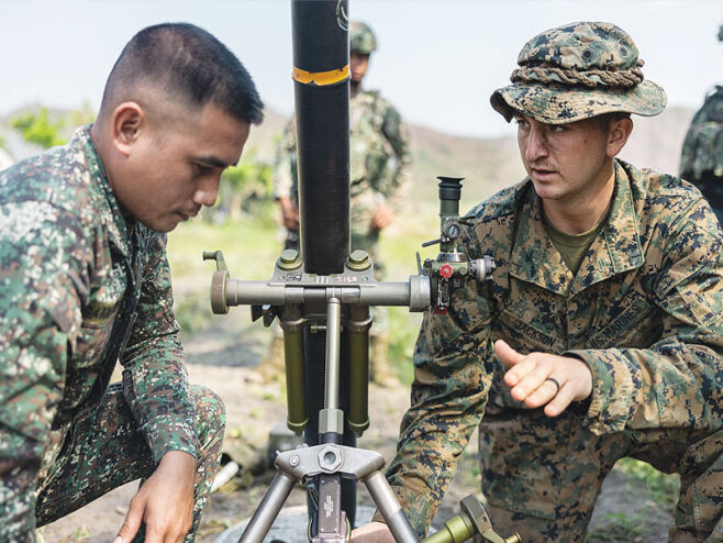 Filipino and American Marines work on a mortar system during a weapons familiarization drill. Photo by the U.S. Marine Corps.